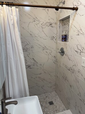 Combined shower/tub, hair dryer, towels, soap