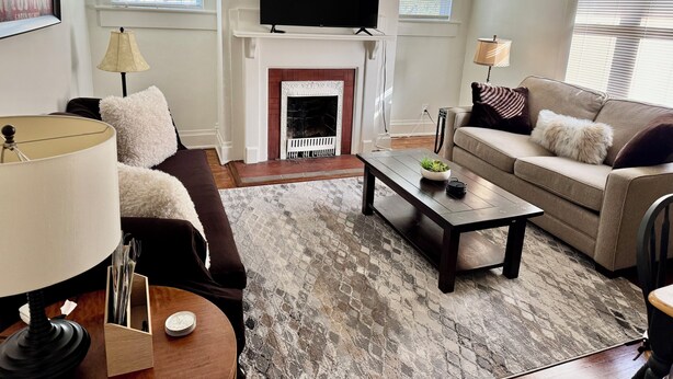 A living room with a fireplace, a television, a sofa, and a coffee table. - #2 UAB 2bd2bth in the heart of city (Birmingham)