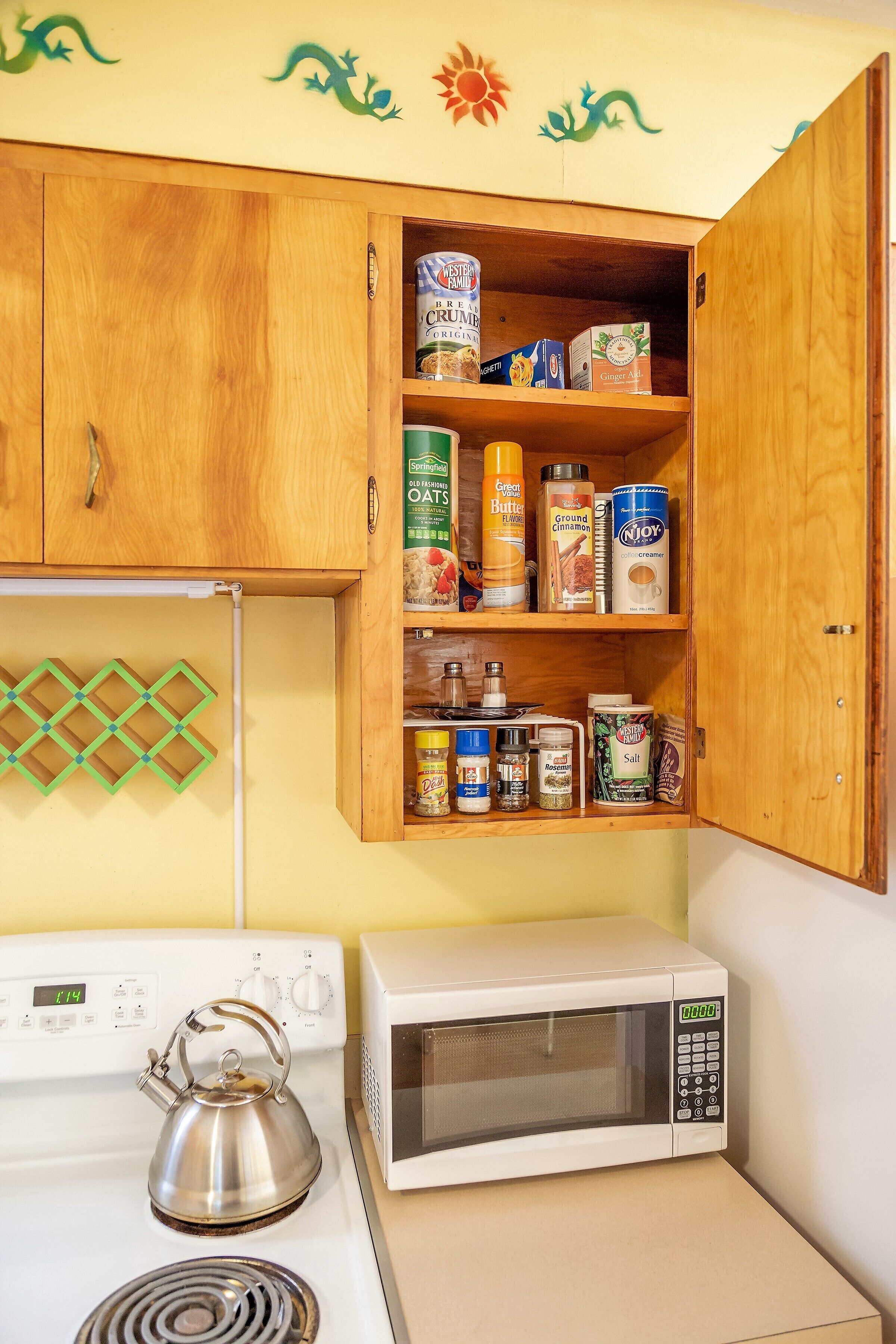 A kitchen with wooden cabinets, a stove, and a microwave.