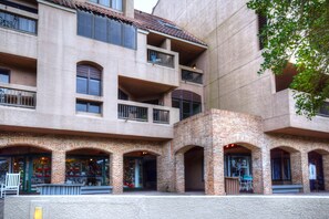 Stylish building with arched windows and balconies, offering outdoor space for occupants.