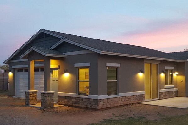 A single-story house with a garage, stone foundation, and a sloped roof. - Two Bedroom, clean guest house in Gilbert (Gilbert)