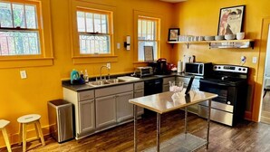 A kitchen with wooden flooring, stainless steel appliances, and a window with a view. - Beautiful Updated Historic 3BD/2BTH Home (Birmingham)