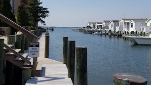 A wooden dock leading to a boat docking area with a sign indicating 'Westward Ho Boat Docking Only'. - Romantic Beach Getaway For 2 In Ocean City MD (Ocean City)