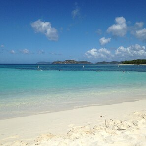 A beach with clear turquoise water, white sand, and distant mountains under a blue sky with clouds. - Paradise Found/Breathtaking Views/ Dedicated Wi-Fi
MONTHLY SPECIAL  6/15 - 11/15 (St Thomas)