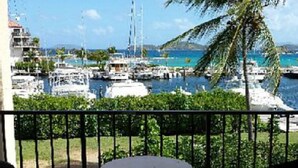 A balcony with a table, overlooking a marina with boats and a clear blue sky. - Paradise Found/Breathtaking Views/ Dedicated Wi-Fi
MONTHLY SPECIAL  6/15 - 11/15 (St Thomas)
