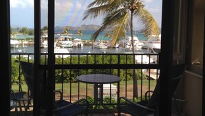 A balcony with a view of a marina, including boats and palm trees. - Paradise Found/Breathtaking Views/ Dedicated Wi-Fi
MONTHLY SPECIAL  6/15 - 11/15 (St Thomas)