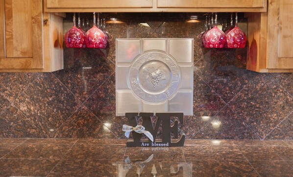 A kitchen counter with a decorative sign that reads "We are blessed" and a logo with a grape design.