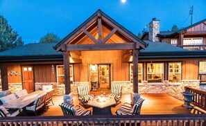 A lodge with a covered patio area featuring a fire pit, outdoor seating, and a stone fireplace. - Bend Country 4 BR/3 Bth, Amazing 9 Mt View, 9 acre, Peaceful Getaway (Terrebonne)