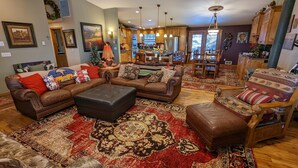 A spacious living room with leather sofas, a coffee table, and patterned rugs. - Bend Country 4 BR/3 Bth, Amazing 9 Mt View, 9 acre, Peaceful Getaway (Terrebonne)