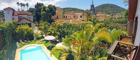 Una piscina al aire libre, sillones reclinables de piscina