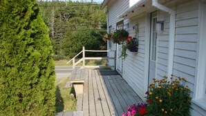 A wooden deck leading to a white house with a white fence, surrounded by greenery. - (3) BEAUTIFUL SUMMER RENTAL Nr ACADIA NATIONAL PARK & BAR HARBOR! 3 (Southwest Harbor)