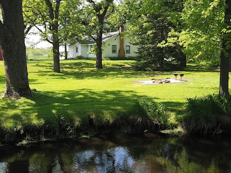 Property grounds. Country home with flowing river