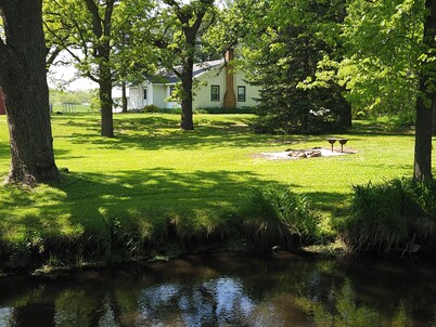 Country home with flowing river
