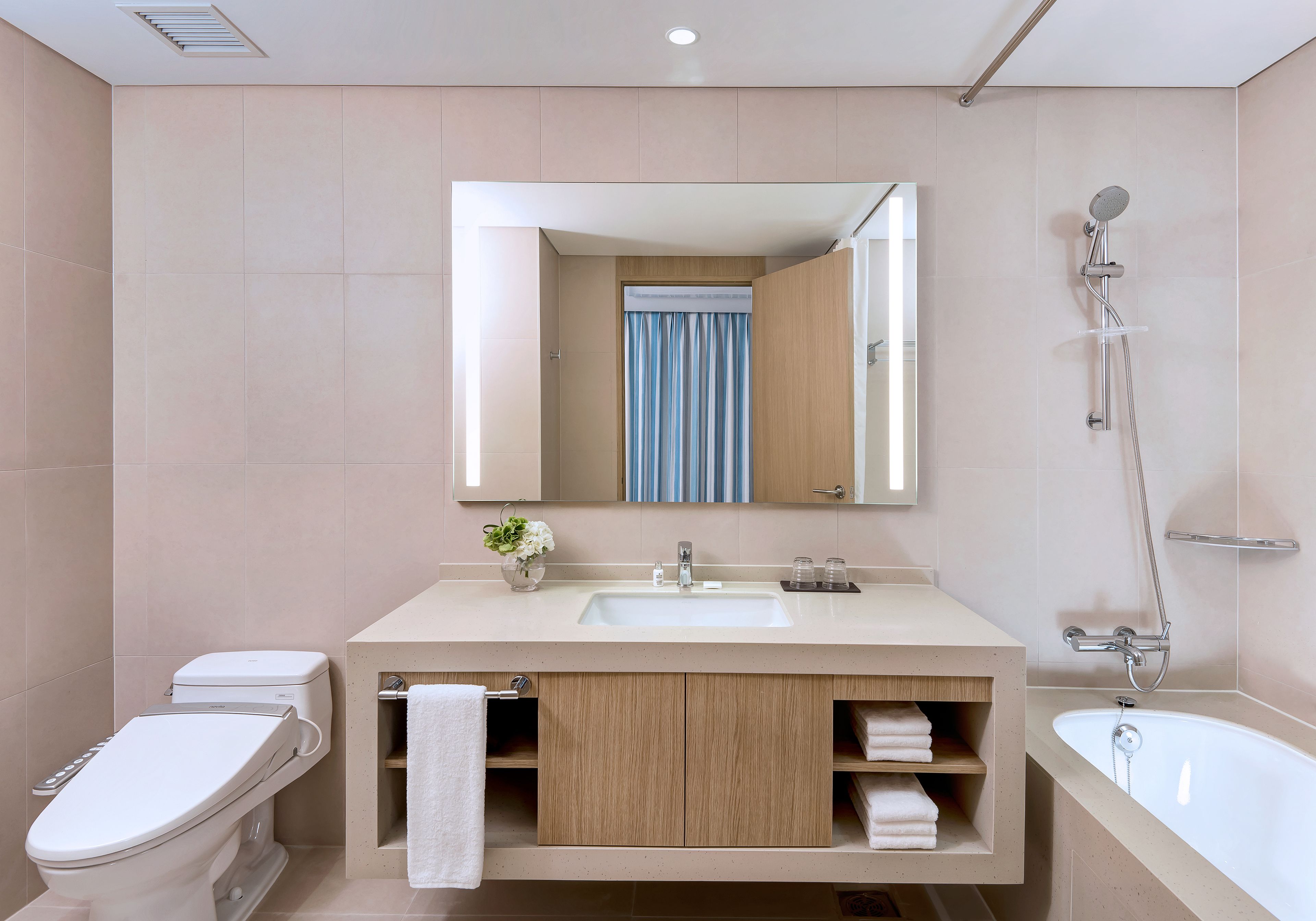 A modern bathroom with a toilet, sink, and bathtub.