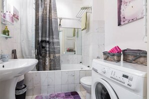 Bathtub, hair dryer, towels, soap