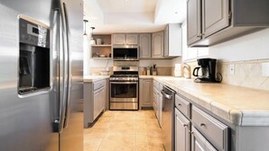 A modern kitchen with stainless steel appliances, a built-in oven, and a coffee maker. - Movie Colony Home with Private Casita, Pool & Spa! (Palm Springs)
