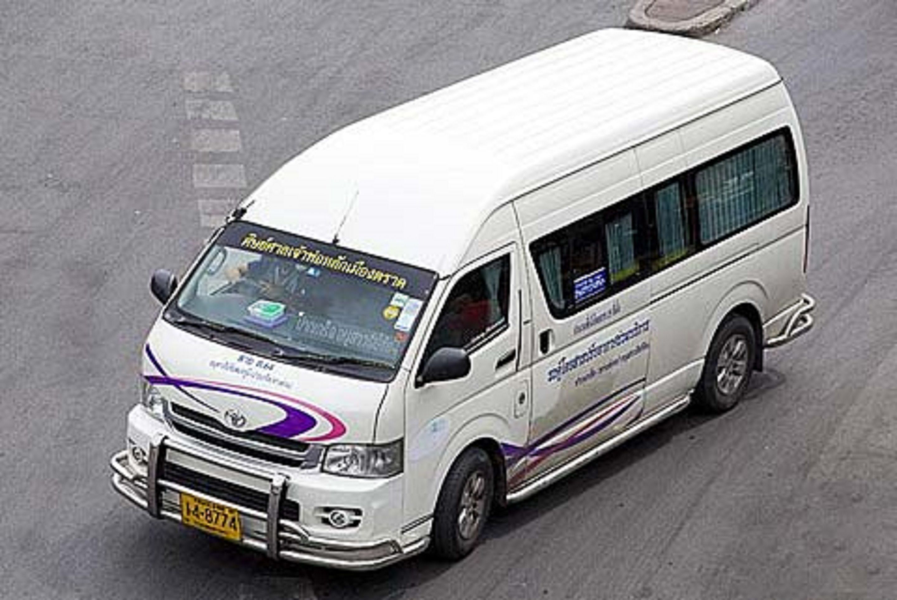 A white van with a front license plate and side decals.