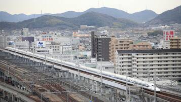A train station with multiple tracks and a train in motion.
