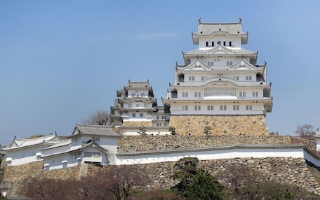 A multi-tiered castle-like structure with traditional architecture, including multiple levels and a stone base.
