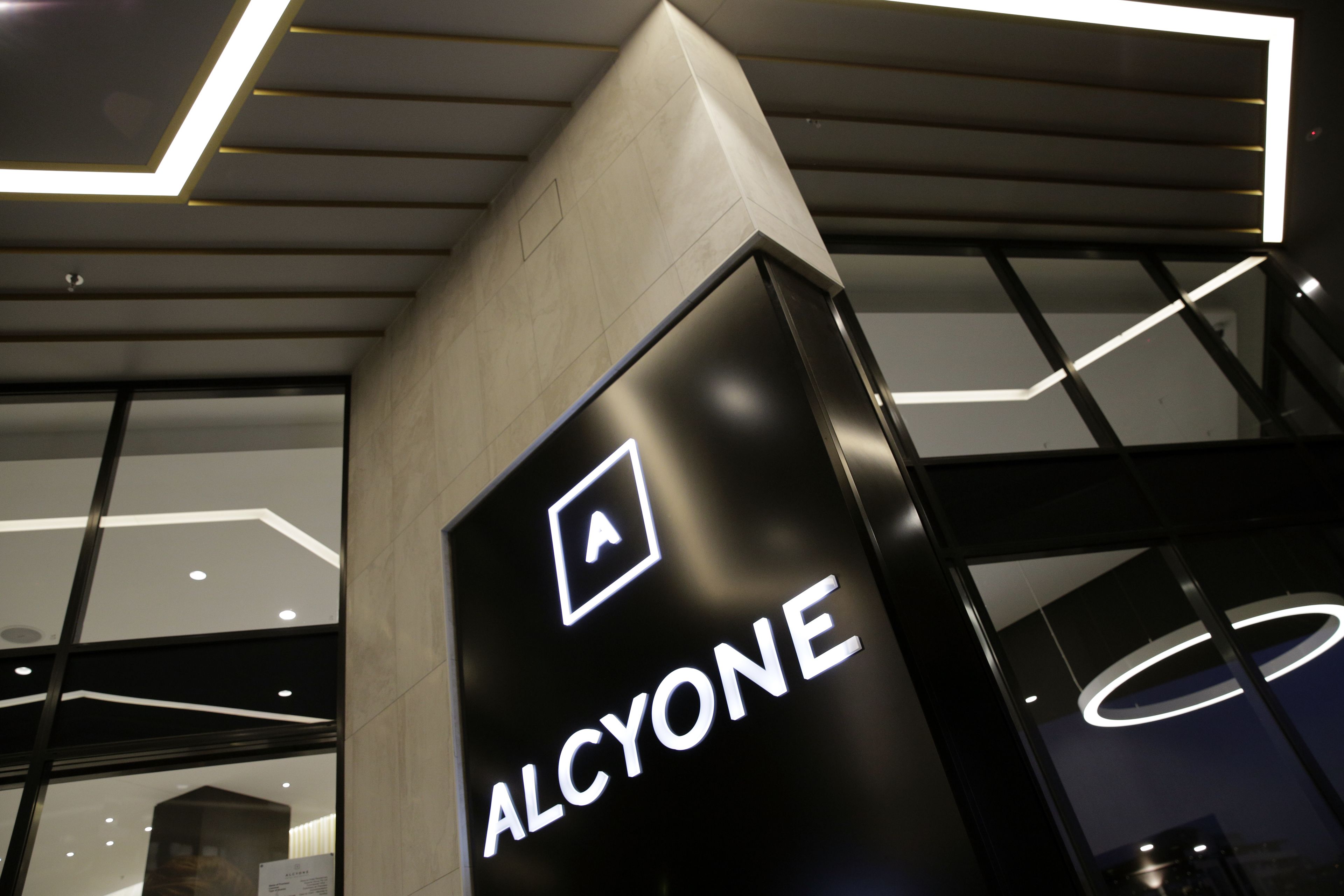 A modern building with a prominent sign reading "ALCYONE".