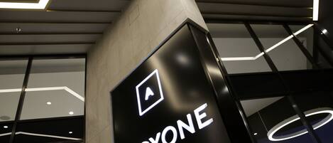 A modern building with a prominent sign reading "ALCYONE".