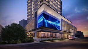 A modern hotel with a prominent glass facade and a rooftop terrace. - Alcyone Hotel Residences (Hamilton)