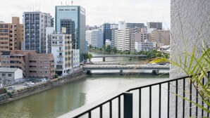 A cityscape with modern buildings, a river, and a bridge. - A Good Day Fukuoka Riverside (Fukuoka)