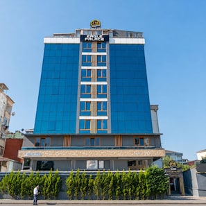 A tall hotel building with a prominent sign reading 'Eagle Palace' and a number '216' on the top. -  216 Eagle Palace Suite (Istanbul)