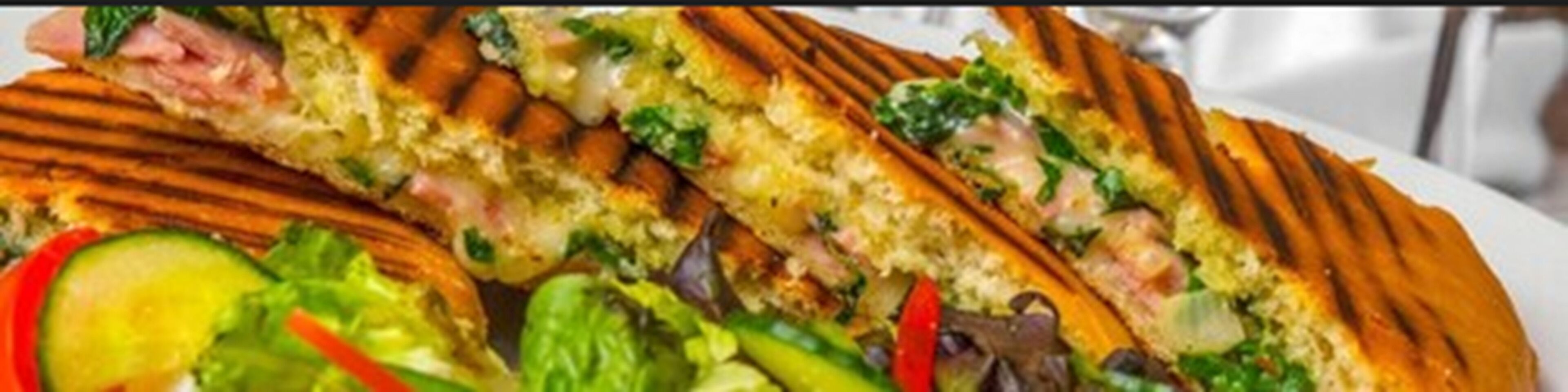 A sandwich cut in half, revealing layers of ingredients.