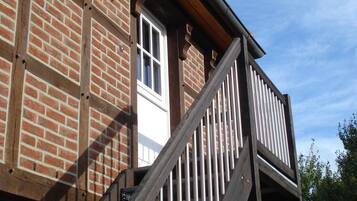 A brick building with a wooden staircase and a window.