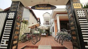 A gated entrance to a property with a sign indicating a homestay and coconut garden. - Coconut Garden Homestay Hoi An (Da Nang)