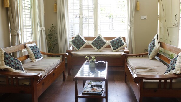 A cozy living room with a sofa set, a coffee table, and a window with curtains. - Hotel Nana Pokhara (Pokhara)