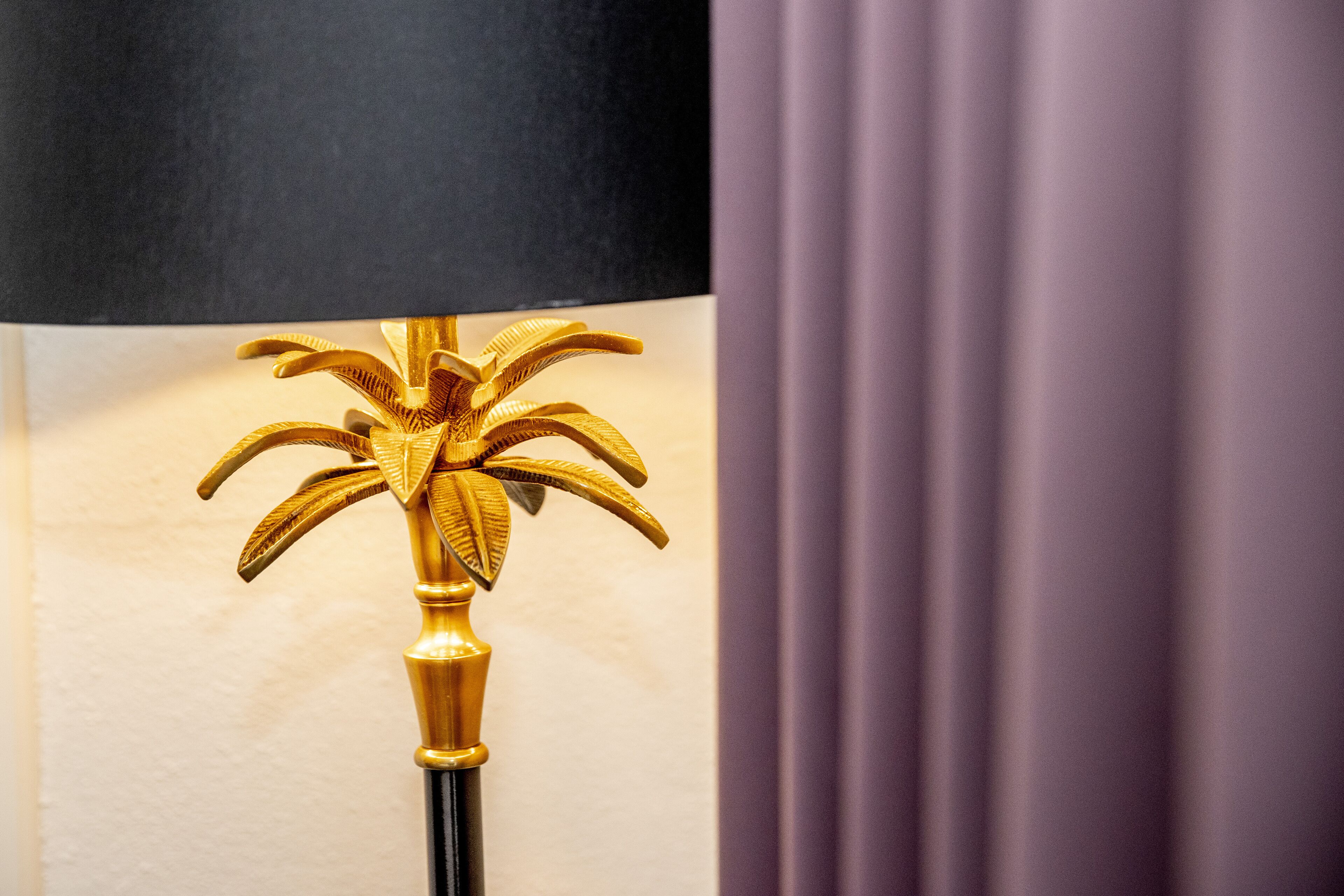 A lamp with a golden, floral design.