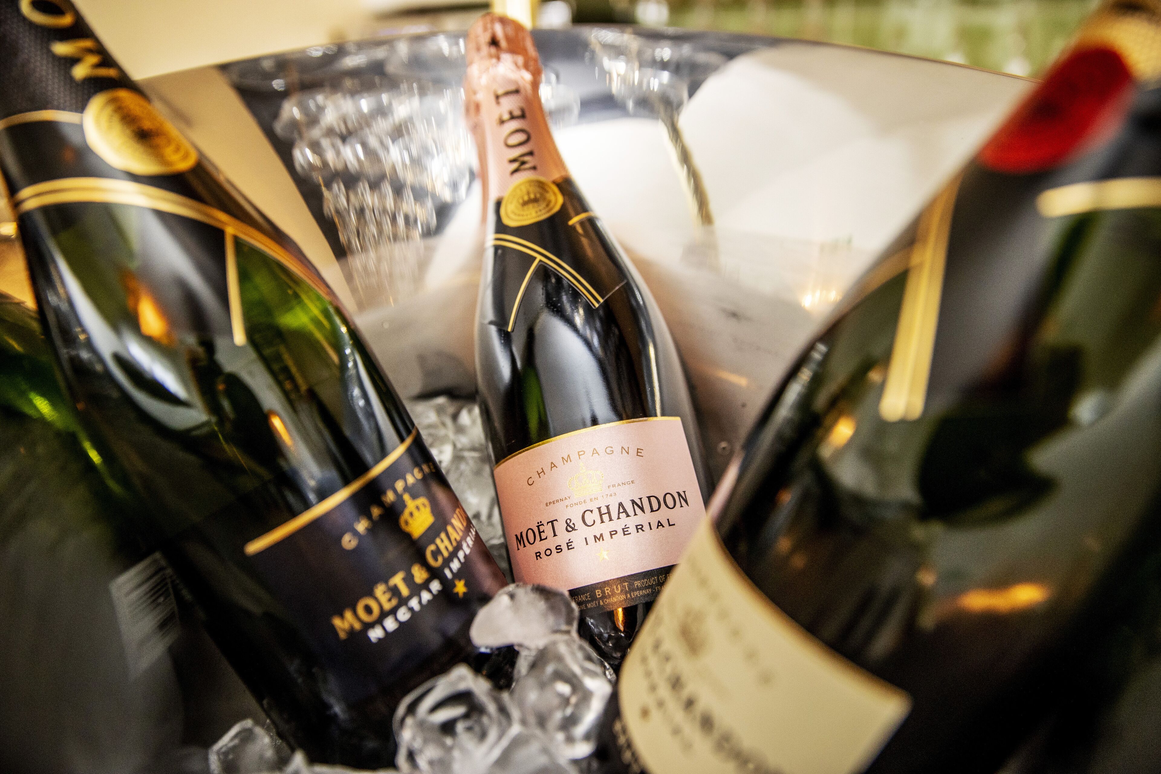 A selection of champagne bottles in an ice bucket.