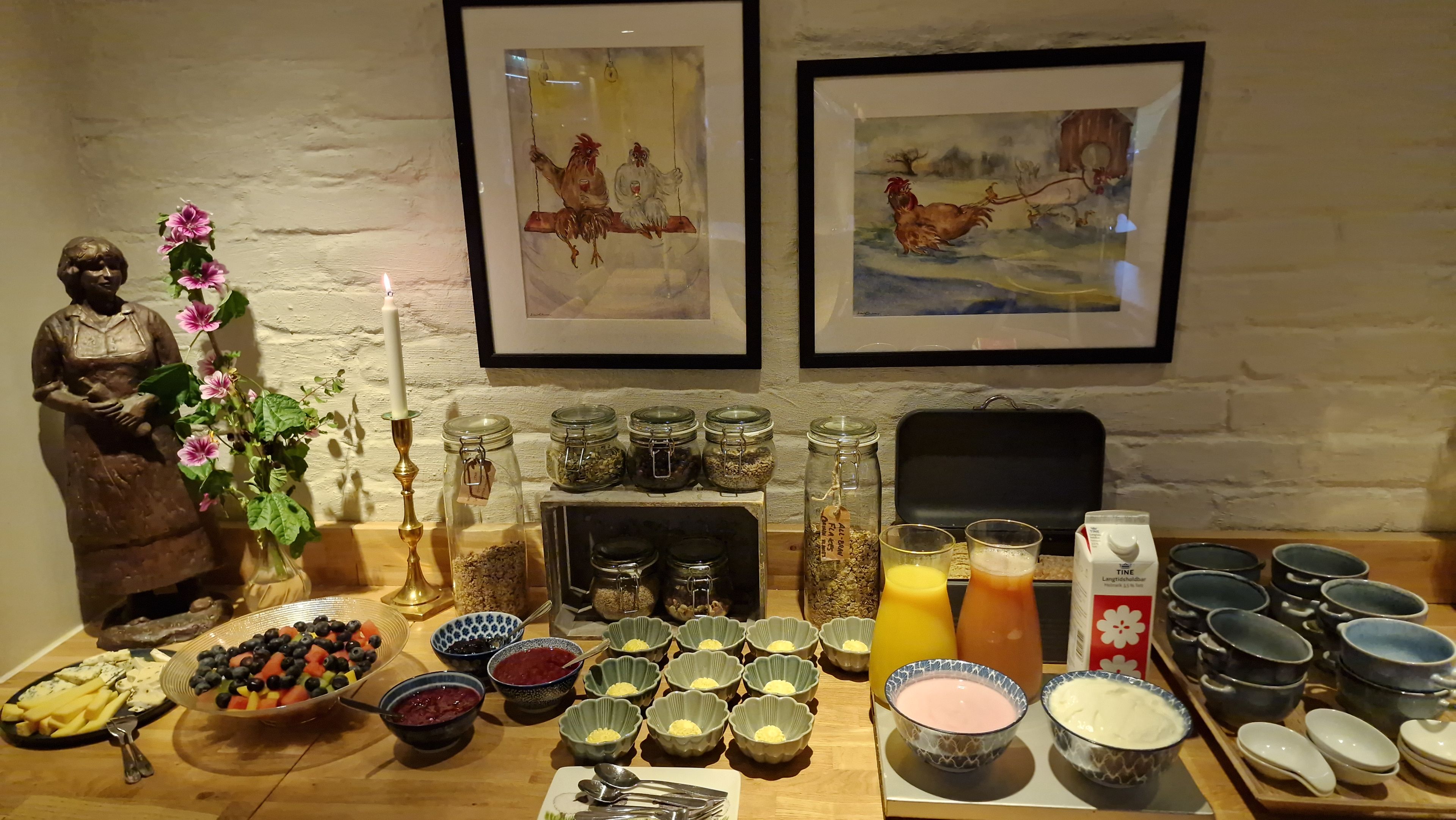 Una mesa con diversos alimentos, frascos y una estatua.