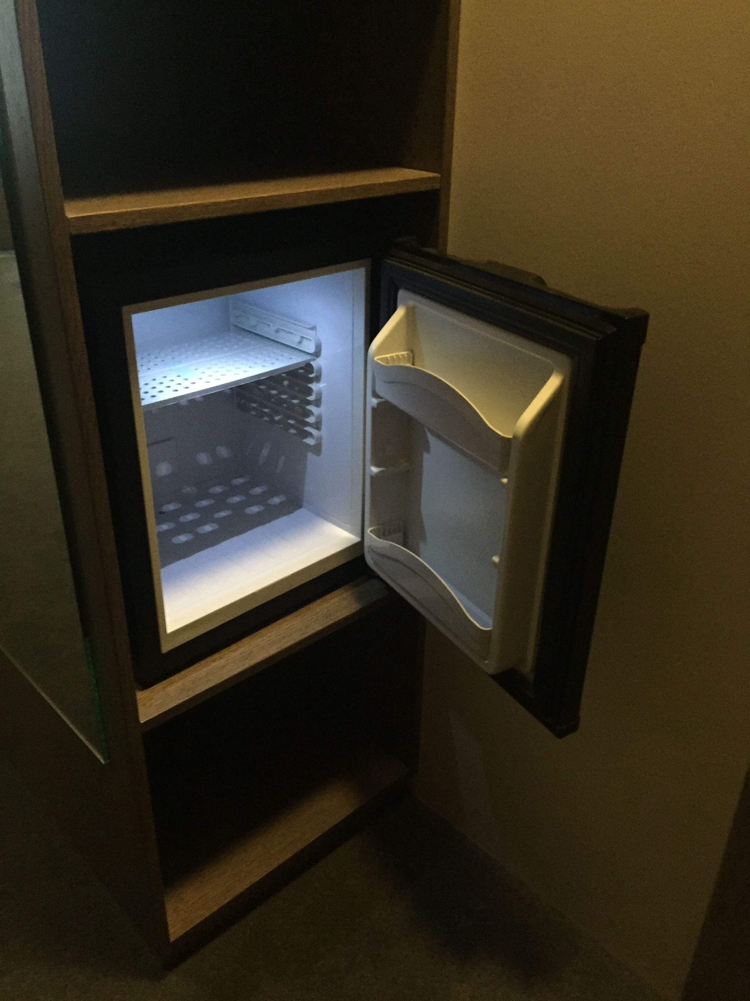 A refrigerator with a freezer compartment on the left and a main compartment on the right.