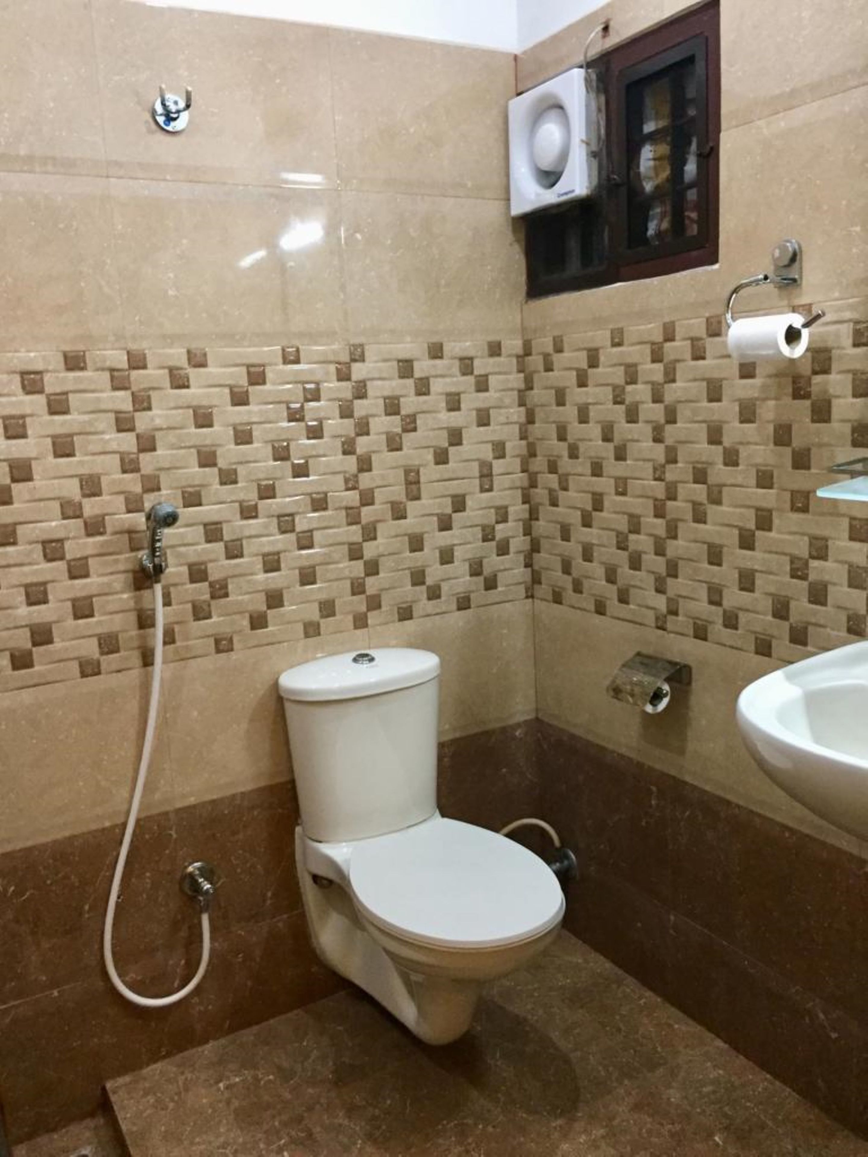 A bathroom with a toilet, a sink, and a shower.