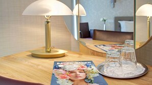 Une table avec un magazine, une lampe et un plateau avec des verres.