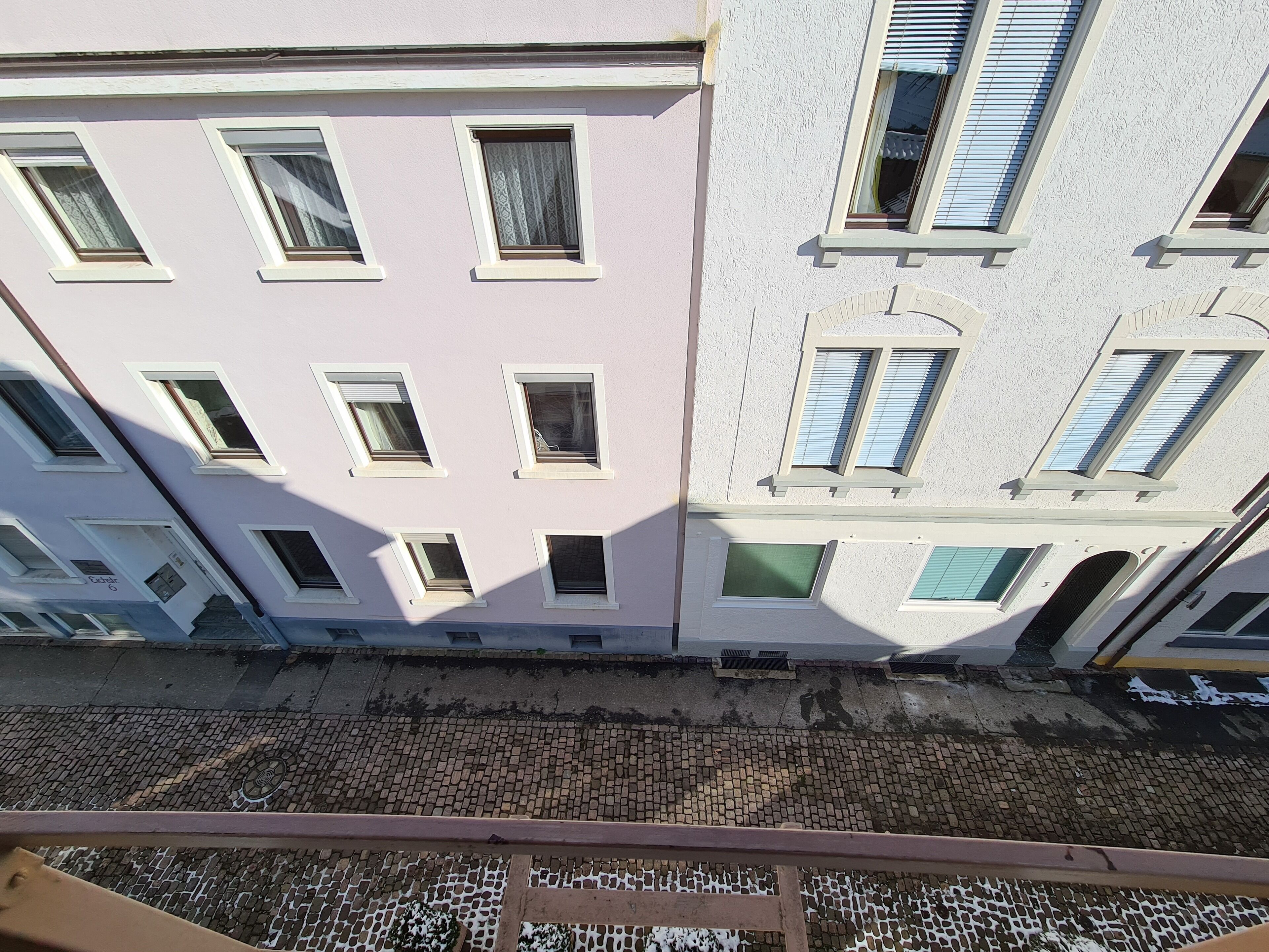 A multi-story building with multiple windows and balconies.