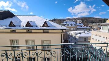 A residential building with multiple balconies and a snow-covered roof.