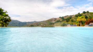 Outdoor pool, open 9:00 AM to 7:00 PM, pool loungers