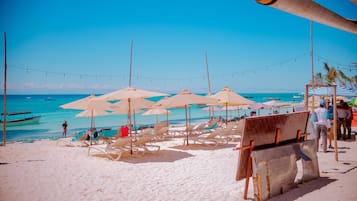 On the beach, sun loungers, beach umbrellas, beach towels