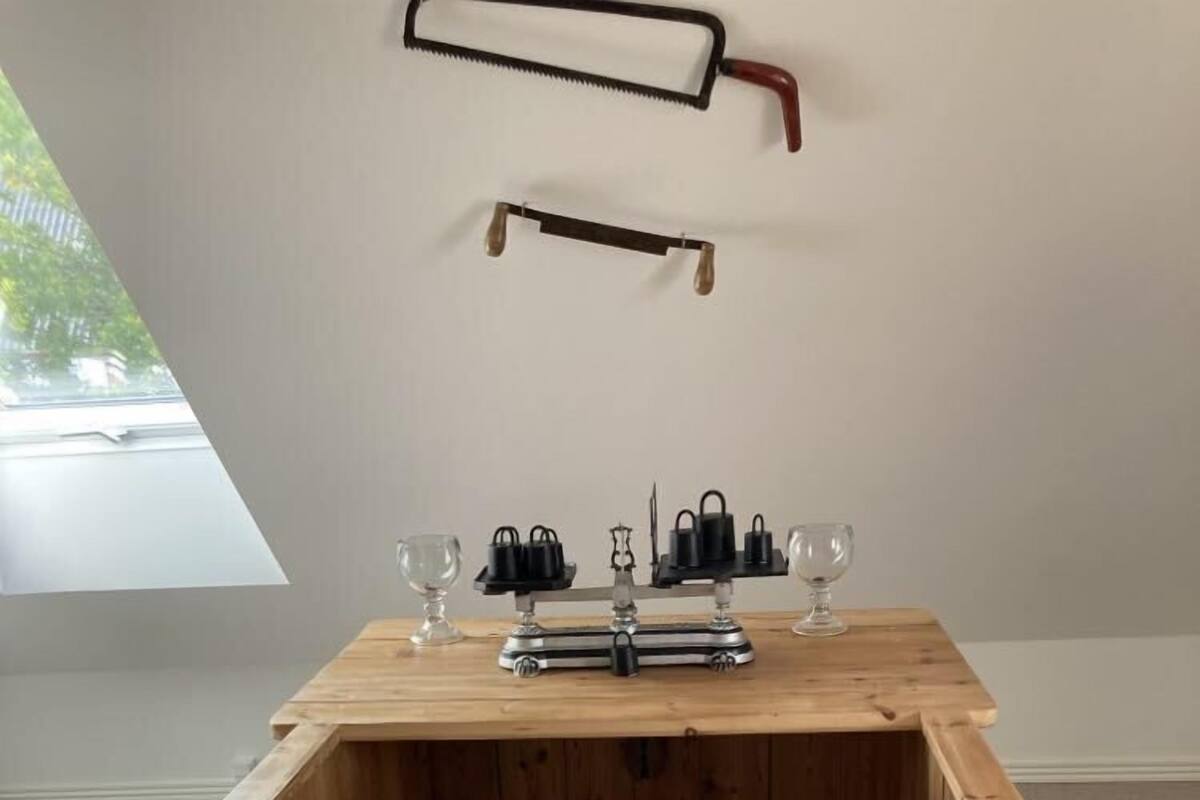 A wooden bar area with a rustic design, including a wooden counter and metal handles.