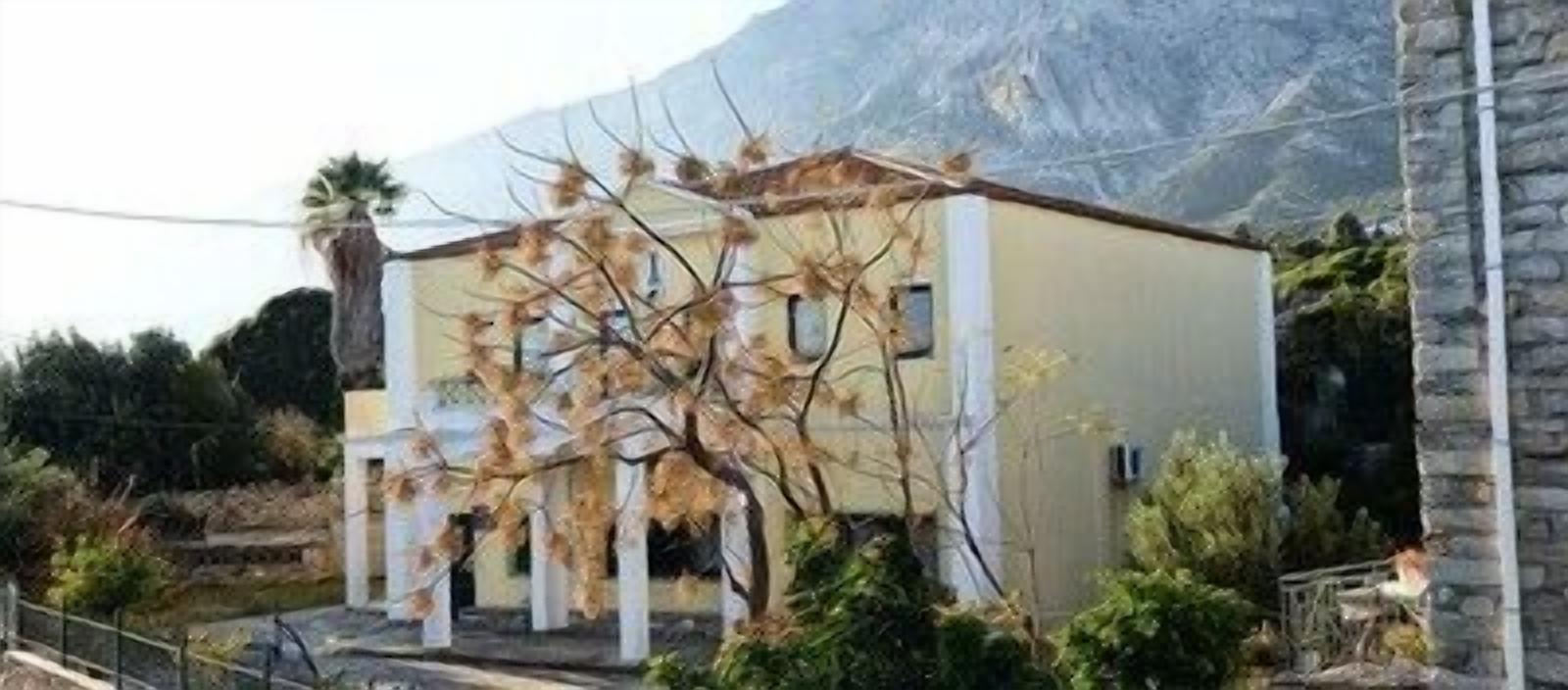 A two-story building with a flat roof and a simple facade.