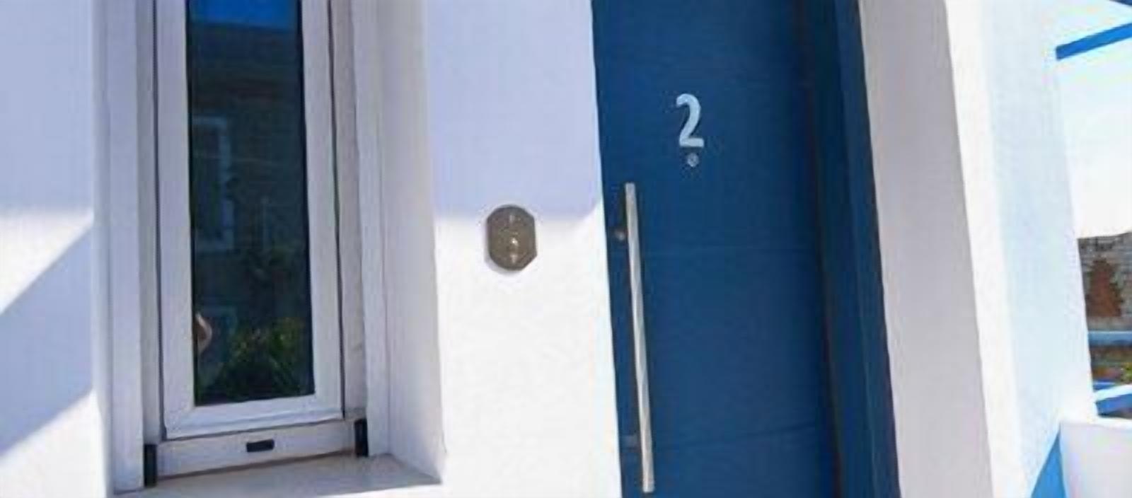A door with a number '2' sign, a window, and a door handle.