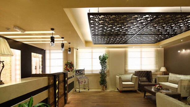 A spacious lobby with a reception desk, seating area, and a decorative ceiling. - Florida Al Souq Hotel (Dubai)