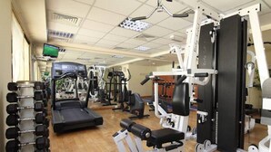 A gym with various exercise equipment, including treadmills, weight machines, and dumbbells. - Florida Al Souq Hotel (Dubai)