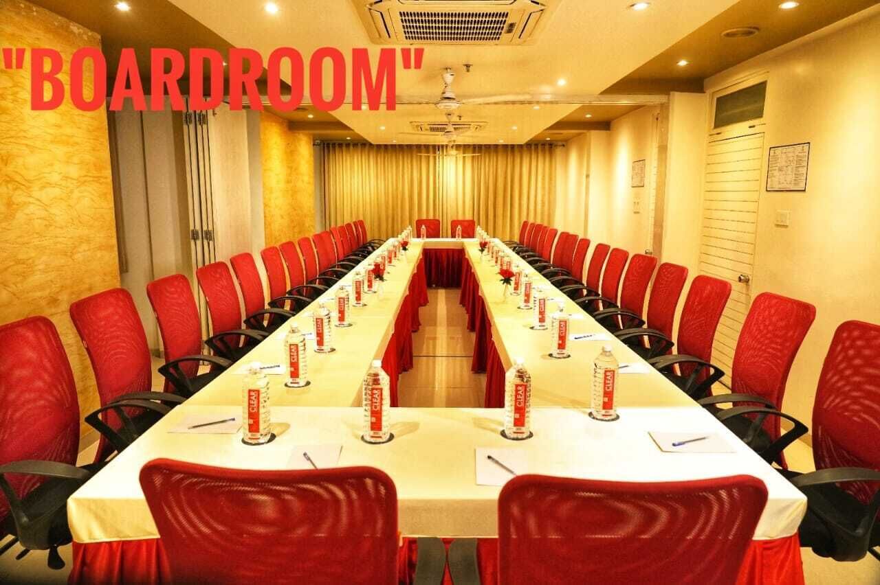 A conference room with a long table, red chairs, and a "BOARDROOM" sign.