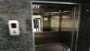 An elevator interior with a digital control panel, metallic walls, and a carpeted floor. - Homeplace Residence (Bangkok)