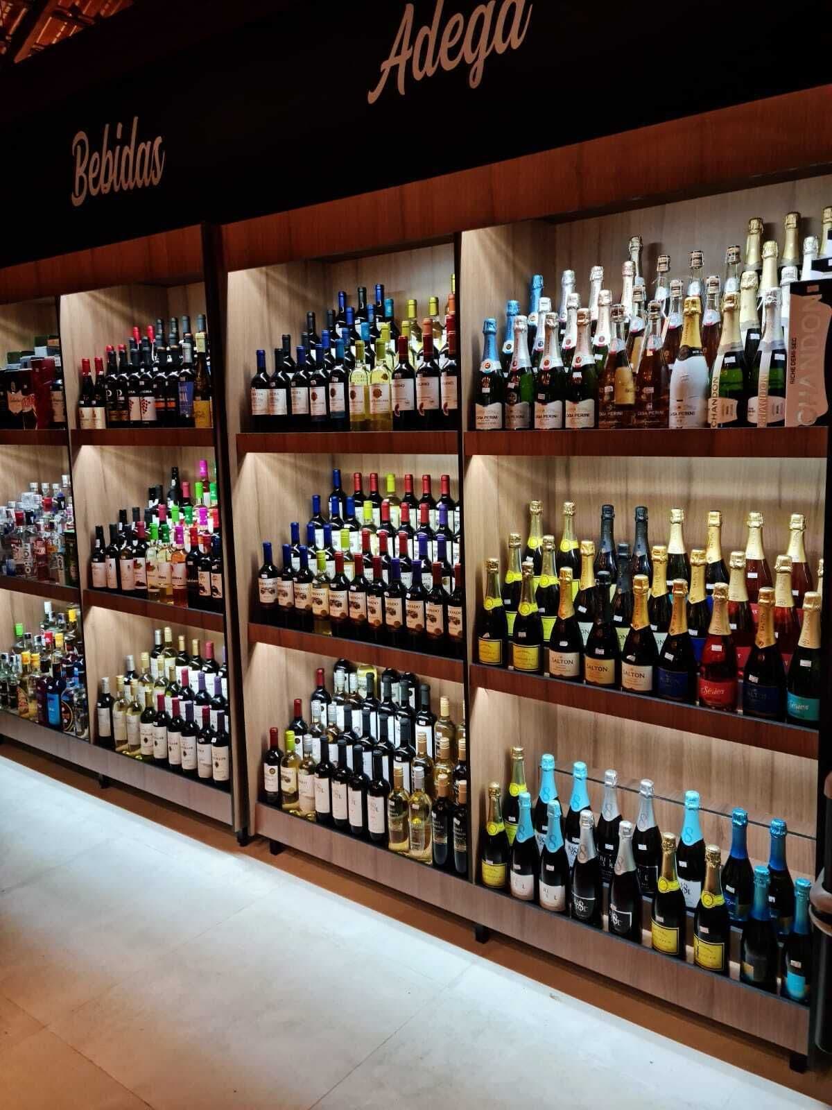 A liquor store with shelves stocked with various bottles of alcohol.
